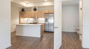 Scottsdale apartment for rent - A kitchen with a white counter and wooden cabinets.