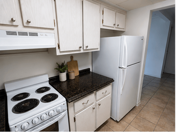 Ft. Lauderdale apartment for rent - A kitchen with a white stove and a white refrigerator.