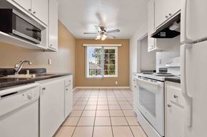Fremont apartment for rent - a kitchen with white appliances and a ceiling fan