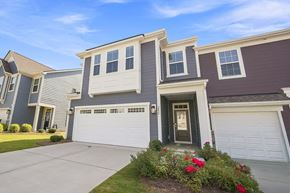 Sherrills Ford townhouse for rent - A house with a grey and brown exterior and a white garage door.