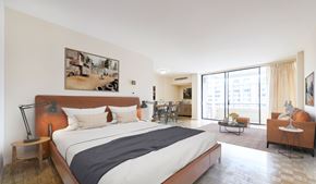 Washington apartment for rent - A bedroom with a large bed and a painting on the wall.