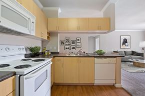 Sacramento apartment for rent - a kitchen with white appliances and wooden cabinets