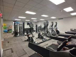 Washington apartment for rent - A gym with treadmills, elliptical machines, and other exercise equipment.