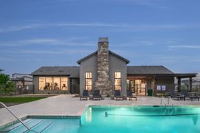Prescott apartment for rent - A modern house with a stone chimney and a pool in front.
