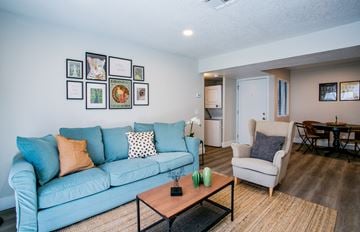 Las Vegas apartment for rent - A living room with a blue couch and a coffee table.
