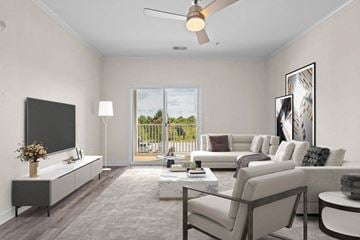 Hickory apartment for rent - A living room with a flat screen TV, a sofa set, a coffee table, and a ceiling fan.