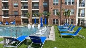 Lewisville apartment for rent - Heritage towers apartments an outdoor pool with lounge chairs and umbrellas in front of an apartment building lewisville tx apartments apartments near lewisville tx lewisville apartments
