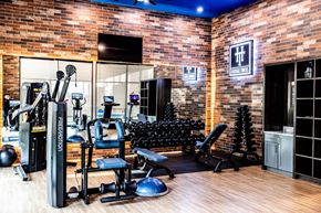 Lewisville apartment for rent - a gym with a lot of equipment and a brick wall