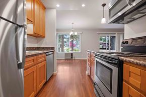 Santa Clara apartment for rent - 2-Bedroom Apartments in Santa Clara, CA - Hidden Lake - Kitchen with Wood-Style Cabinets, Granite Countertops, Stainless Steel Appliances, and Double Sink.