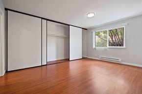 Santa Clara apartment for rent - Apartments in Santa Clara, CA, for Rent - Hidden Lake - Spacious Bedroom with Oversized Closet with Sliding Doors, Large Window, Wood-Style Flooring, and High Ceiling.