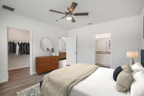 Palm Bay townhouse for rent - A bedroom with a large bed and a ceiling fan.