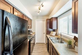 Charlotte apartment for rent - Modern kitchen with black appliances and sleek countertops at Hunters Pointe apartments in Charlotte, NC 28213, near UNC Charlotte