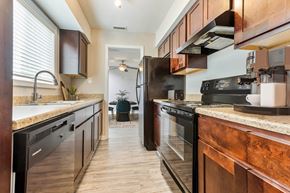 Charlotte apartment for rent - Modern kitchen with black appliances at Hunters Pointe apartments in Charlotte, NC 28213, near UNC Charlotte