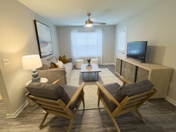 Hattiesburg apartment for rent - A living room with two chairs and a couch.