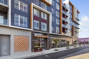 Oakland apartment for rent - A modern building with a large mural on the side.
