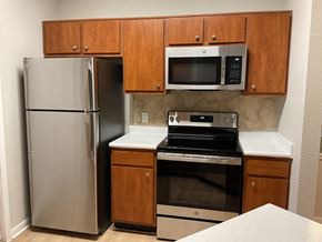 San Antonio apartment for rent - a kitchen with stainless steel appliances and wooden cabinets
