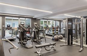 Oakland apartment for rent - A gym with a variety of equipment including treadmills, weights, and exercise machines.