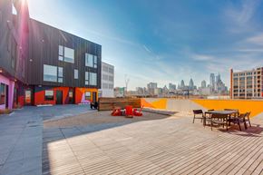 Philadelphia apartment for rent - A modern building with a wooden deck and orange accents.
