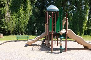 Greensboro apartment for rent - A playground with a green slide and a yellow slide.