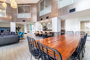Milpitas apartment for rent - a large dining room with a long wooden table and chairs
