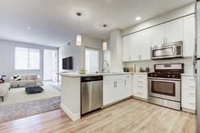 Milpitas apartment for rent - Apartments in Milpitas, CA with In-Unit Washer and Dryer - Ilara Apartments - Kitchen with Modern White Cabinets, Stainless Steel Appliances, and a Breakfast Bar