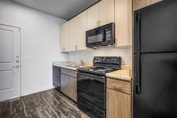 Phoenix apartment for rent - a kitchen with black appliances and wooden cabinets