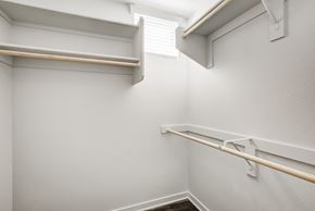Phoenix apartment for rent - Apartments for Rent in Phoenix, AZ - Imperial - Oversized Closet with White Walls, Built-In Shelves, Wooden Rods, and Wood-Style Flooring