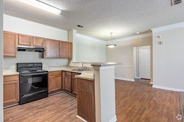 East Point apartment for rent - A kitchen with wooden cabinets and a black oven.