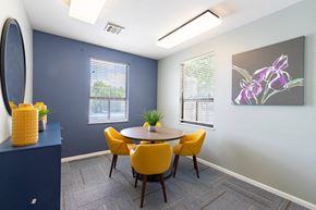San Antonio apartment for rent - A dining room with a round table and yellow chairs.