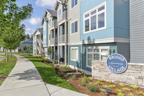 Olympia apartment for rent - A row of townhouses with a sign that says Briggs Apartments Village.