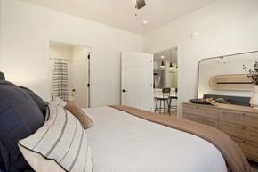 Verdi apartment for rent - A bedroom with a large bed and a mirror on the wall.