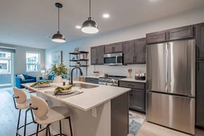 Kenosha apartment for rent - A modern kitchen with a large island and stainless steel appliances.