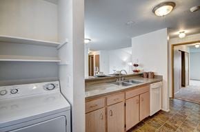 Bothell apartment for rent - A white oven is in a kitchen with wooden cabinets.