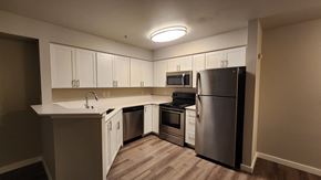 Renton apartment for rent - A kitchen with a refrigerator, oven, and microwave.