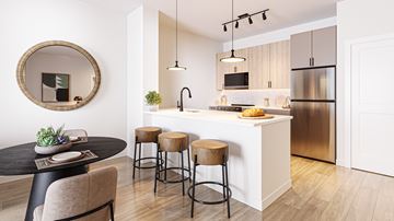 Aurora apartment for rent - A modern kitchen with a round table and bar stools.