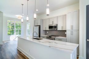 Atlanta apartment for rent - Modern kitchen featuring a large island and stainless-steel appliances at La France Square in Atlanta, GA, a pet-friendly community.