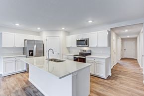 Fort Wayne townhouse for rent - a large kitchen with white cabinets and a white counter top