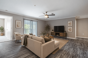 Calera apartment for rent - Bright open-concept living room at Lancaster Place Apartments in Calera, Alabama featuring wood-style flooring, abundant natural light, and a spacious layout.