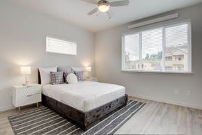 Vancouver apartment for rent - a bedroom with a bed and a ceiling fan