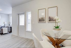 Vancouver apartment for rent - a dining room with white chairs and a glass table