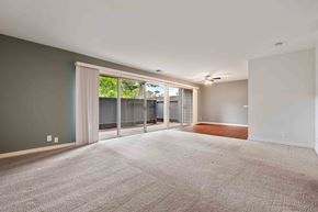 Fremont apartment for rent - Pet-Friendly Apartments in Fremont, CA - Logan Park Apartments - Spacious Living Room With Sliding Glass Doors, Private Patio Access, Neutral Walls, and Adjacent Dining Area.