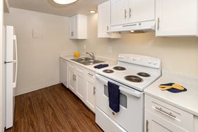 Reno apartment for rent - a kitchen with white cabinets and white appliances