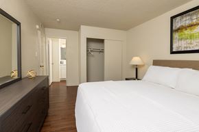 Reno apartment for rent - a bedroom with a bed and a dresser in a room