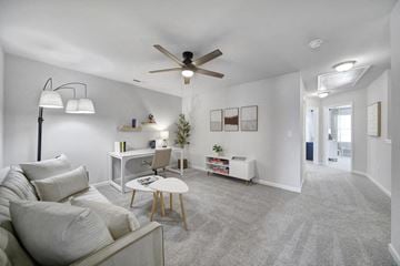 Indian Trail townhouse for rent - A living room with a grey carpet and a white couch.