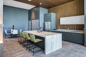 Miami apartment for rent - Miami, FL Apartments - MB Station - Clubhouse with Large Modern Kitchen, Table and Chairs, and Kitchen Island with Bar-Style Seating.