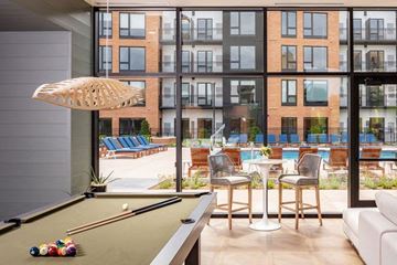 Edina apartment for rent - a living room with a pool table and an outside patio