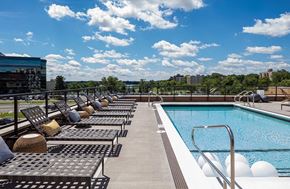 Minneapolis apartment for rent - a swimming pool on top of a building with lounge chairs