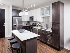 Minneapolis apartment for rent - a kitchen with a center island and a stainless steel refrigerator