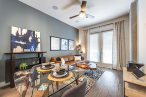 Dallas apartment for rent - A modern dining room with a glass table and chairs.
