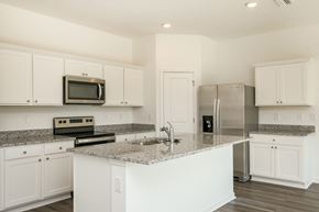 Zephyrhills apartment for rent - A kitchen with white cabinets and a granite countertop.